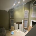 The before of a custom wall and lighting installation as part of a living room installation