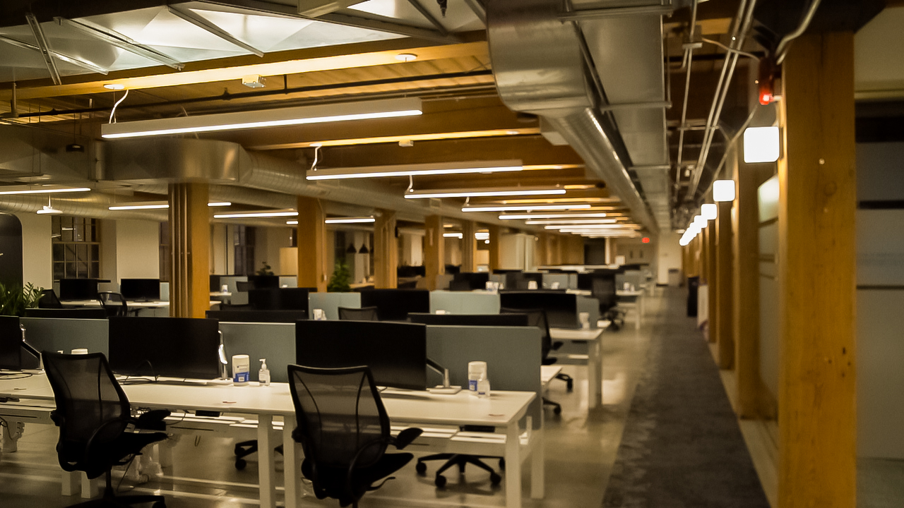 A row of desks in a corporate office that had commercial lighting installed by Titan General