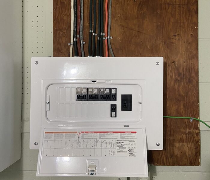 Close up of an electrical panel on the wall in a basement that was serviced by Titan General